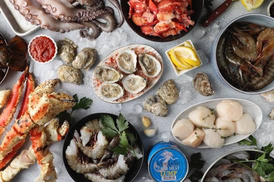 Seafood market display — oysters, crab, fish on ice